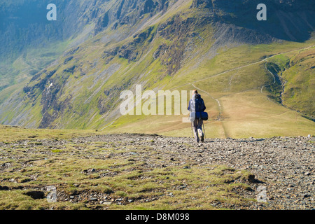 A hiker Walking down from Sand Hill to Coledale Hause in the Lake District Stock Photo
