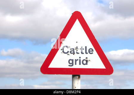 Cattle grid warning sign with bullet holes, England, UK Stock Photo - Alamy