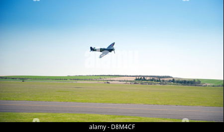 A Supermarine Spitfire flying over Duxford Aerodrome,Cambridgeshire. Stock Photo