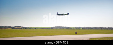 A Supermarine Spitfire flying over Duxford Aerodrome,Cambridgeshire. Stock Photo