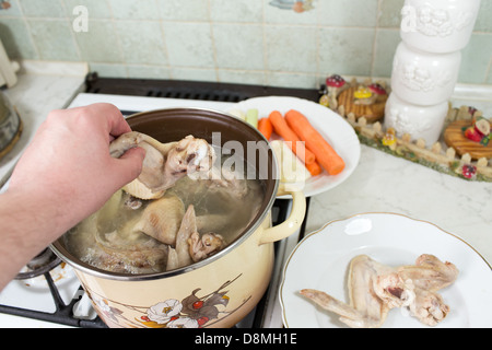 Preparation of broth with chicken, turkey, beef, and vegetables. Polish cuisine. Stock Photo