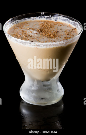 classic drink brandy alexander with fresh nutmeg on top served in a stemless martini glass over a black background Stock Photo