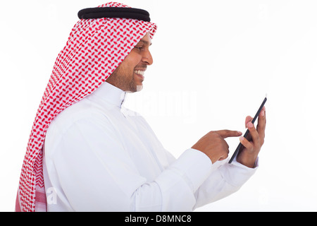 side view of cheerful arabian man using tablet computer on white background Stock Photo