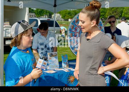 Concord, Massachusetts, USA. 31st May 2013. Fox25 Lilly Hopkins engages in banter with Junior Reporter Dustin Noke at the Canobie Lake Park booth during the Fox 25 Boston Zip Trip. Credit:  Mark Nassal/Alamy Live News Stock Photo