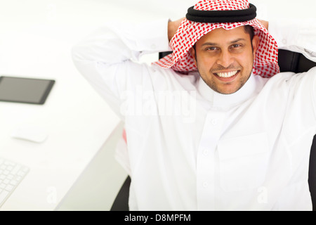 above view of smiling middle eastern businessman relaxing in office Stock Photo