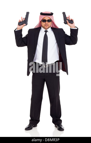 middle eastern hitman in black suit holding two handguns on white background Stock Photo