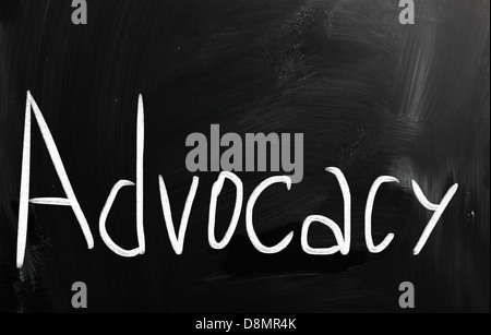 The word 'Advocacy' handwritten with white chalk on a blackboard Stock Photo