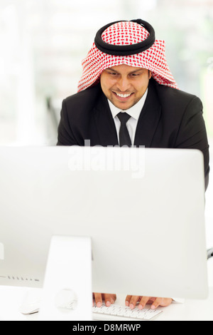 happy middle eastern businessman working on the computer Stock Photo