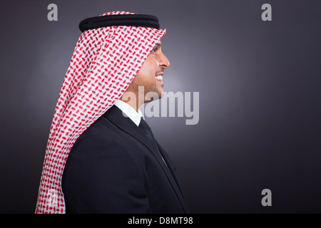 side view of smiling arabian man in black suit Stock Photo