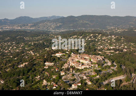 AERIAL VIEW. Medieval hilltop village of Mougins with the city of Cannes in the distance. French Riviera, Alpes-Maritimes, France. Stock Photo