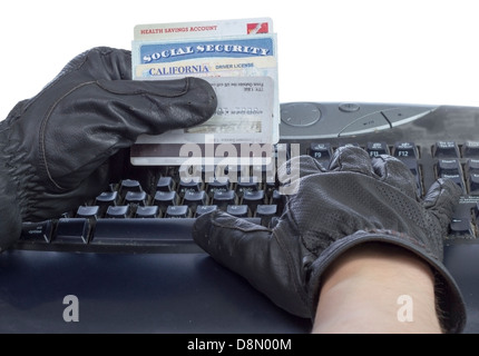 Identification documents (social security, driver license and credit cards) in hand of thief, isolated on white. Stock Photo