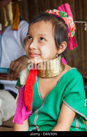 Karen Padong tribe girl in green dress in a village near Chiang Rai, northern Thailand, refugee from Myanmar Stock Photo