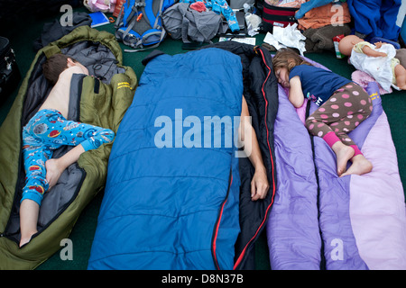 Family sleeping on the deck of the ferry to Alaska. Inside Passage route. Alaska Stock Photo