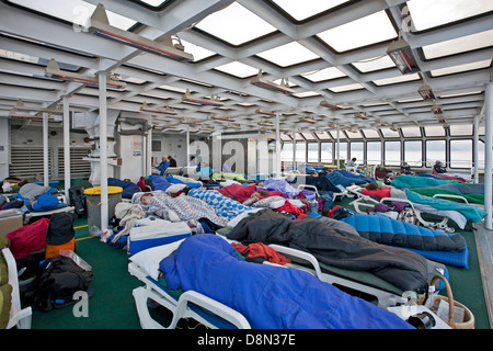 Passengers sleeping on the solarium. Columbia ferry. Inside Passage route to Alaska. USA Stock Photo