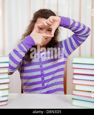 Little girl with piles of books Stock Photo - Alamy