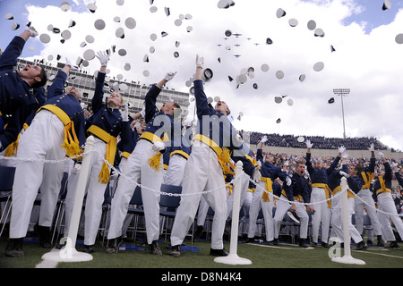 Newly minted second lieutenants of the US Air Force Academy Class of 2013 toss their hats in the air at graduation ceremonies at the Academy's Falcon Field May 29, 2013 in Colorado Springs, CO. Stock Photo