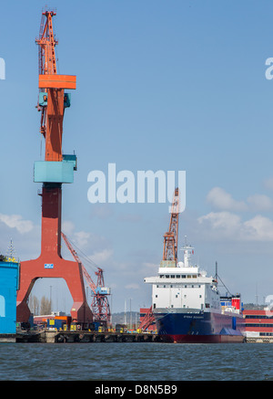 Industrial cranes at a shipyard and floating dry dock in Gothenburg, Sweden Stock Photo