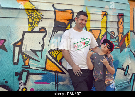 Portrait of Scottish graffiti artist & his son in front of their wall at 5 Pointz in Long Island City, Queens, New York Stock Photo