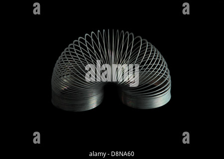 slinky spring toy on black background Stock Photo