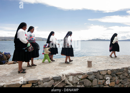 Local people meeting tourists on the pier of Amantani Island, Lake Titicaca, Peru, South America