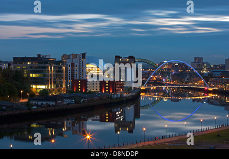 A dusk view of Newcastle and Gateshead quayside with reflections in the River Tyne looking towards the Tyne Bridge Stock Photo