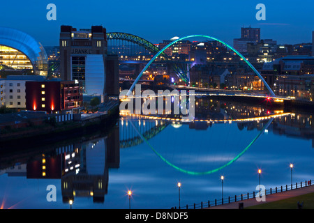 A dusk view of Newcastle and Gateshead quayside with reflections in the River Tyne looking towards the Tyne Bridge Stock Photo