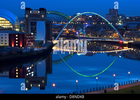 A dusk view of Newcastle and Gateshead quayside with reflections in the River Tyne looking towards the Tyne Bridge Stock Photo