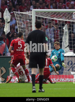 Berlin, Germany. 1st June, 2013. Munich's goalkeeper Manuel Neuer (R) saves the ball against Stuttgart's Georg Niedermeier (2nd L) next to Munich's  Daniel van Buyten (L) during the German DFB Cup final soccerh between FC Bayern Munich and VfB Stuttgart at the Olympic Stadium in Berlin, Germany, 01 June 2013. Photo: Kay Nietfeld/dpaf-time).ther utilisation and publication of the pictu Stock Photo