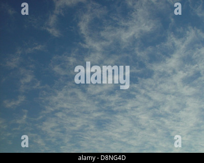 Soft, thin clouds float across the sky, creating a delicate and airy atmosphere. These wispy clouds are often seen in clear weather, adding a light touch to the sky's appearance. Stock Photo