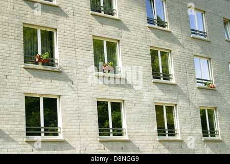 This image features the windows of an old house, showing their age and character. The windows are framed by worn wooden elements and weathered glass, reflecting the house’s history and charm. Stock Photo