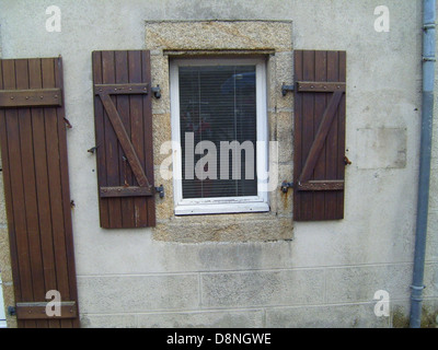 An old-fashioned wooden window with a rustic design, showing the charm of vintage architecture. These types of windows are often found in historical buildings, cottages, or country homes. Stock Photo