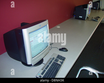 A workspace featuring multiple computer workstations, each equipped with monitors, keyboards, and other essential office tools, suitable for a productive work environment. Stock Photo