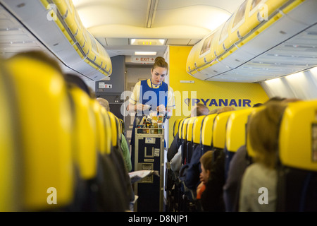 Cabin crew serving on  Ryanair flight Stock Photo