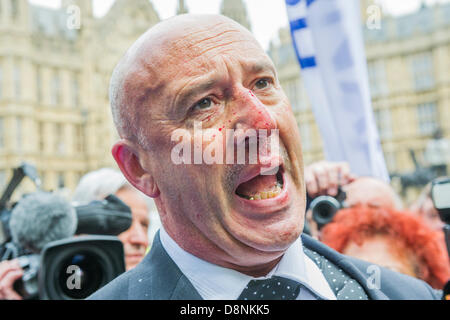 Westminster, London, UK. 1st June, 2013. Lee May gets a bloody nose while trying to get through the anti facist crowd, but finally makes it to the BNP area. A small group from the BNP try to march to ask for the closure of mosques and the Westminster, London, UK. 1st June, 2013. A small group from the BNP try to march to ask for the closure of mosques and the  policemen riot bl of radical clerics.  Their intended route was to Whitehall but are blocked by left wing protestors outside the Houses of parliament. Some arrests are made and police dogs are used as a buffer. Credit:  Guy Bell/Alamy Li Stock Photo