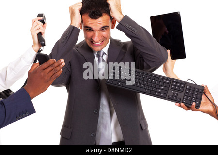 frustrated businessman around by multiple office tools Stock Photo