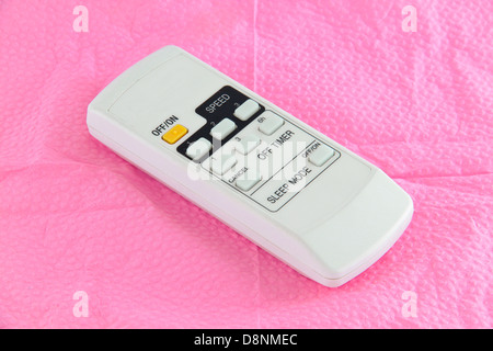 Ceiling fan remote controller. Concept of household appliances. Stock Photo