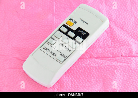Ceiling fan remote controller. Concept of household appliances. Stock Photo
