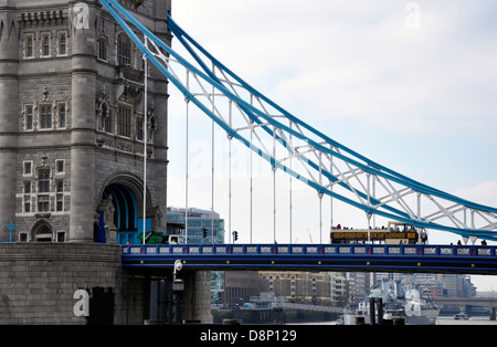 Close-up of the historic landmark, Tower Bridge, with Thames river view and a London tour bus crossing the bridge. London, England, UK. Stock Photo