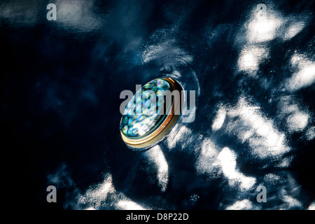 Porthole and reflections on the hull of the Royal Yacht Britannia, berthed in Leith, Edinburgh Stock Photo