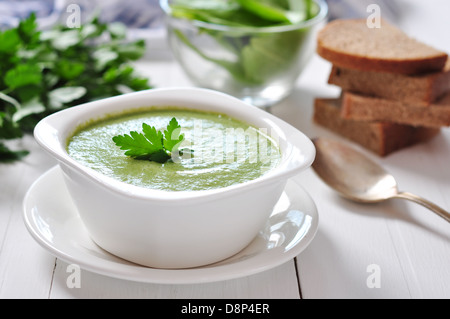 spinach soup in a bowl on a wooden background Stock Photo