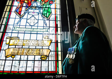 2nd June 2013, Belfast, Northern Ireland. Derek Wilson, who served with the 6th Batallion, UDR from 3rd March 1970, and currently President of the Castlederg UDR memorial branch, admires the newly refurbished window in Belfast City Hall, to commemorate the men and women who served under the UDR during The Troubles. Stock Photo