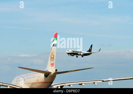 Rear view of an Etihad Airways Airbus A330 aircraft waiting for a Ryanair Boeing 737 to land at East Midlands Airport .