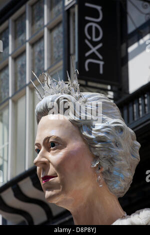 Chester, UK. 2nd June 2013. Next sign and Queen Elizabeth II at the Chester Giant Festival, celebrating Elizabeth II’s Jubilee Coronation.The theme this year is BUGS! Highlighting the plight of the humble bumble bee.  Credit:  Cernan Elias/Alamy Live News Stock Photo
