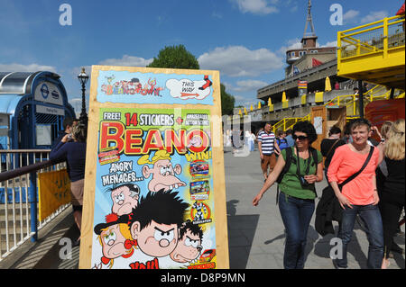 Southbank Centre, London, UK. 2nd June 2013. People walk past a poster for Beanotown, a celebration of the children's comic. Beanotown in the Southbank Centre in London, 'Beanotown is the home of Dennis the Menace and Gnasher, The Bash Street Kids, Minnie the Minx, Roger the Dodger, plus all the other comic strip superstars from The Beano'. Beanotown is on from 31st May to 8th September. Credit:  Matthew Chattle/Alamy Live News Stock Photo