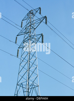 electricity pylon or transmission tower part of the national grid against a blue sky Stock Photo