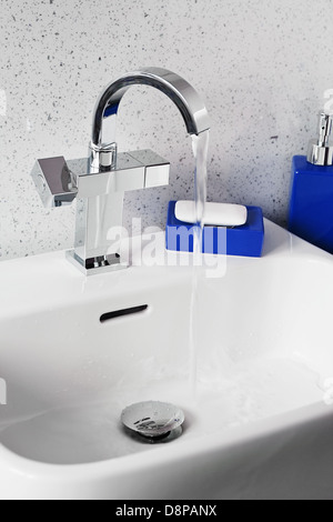 Mixer tap on a contemporary modern bathroom sink Stock Photo