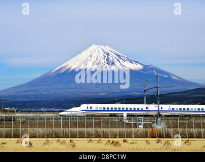 A bullet train passes below Mt. Fuji in Japan. Stock Photo