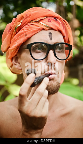 Portrait of a man smoking pipe in glasses Stock Photo