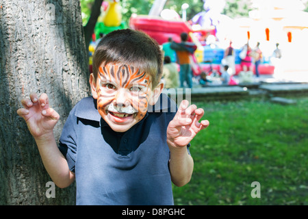 Child with painted face. Tiger paint. Boy on children's holiday Stock Photo