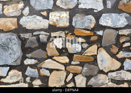 background of a pattern with textured stone blocks on a wall Stock Photo